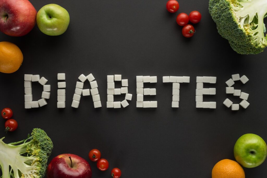 diabetes lettering made of sugar cubes among fruits and vegetables on black